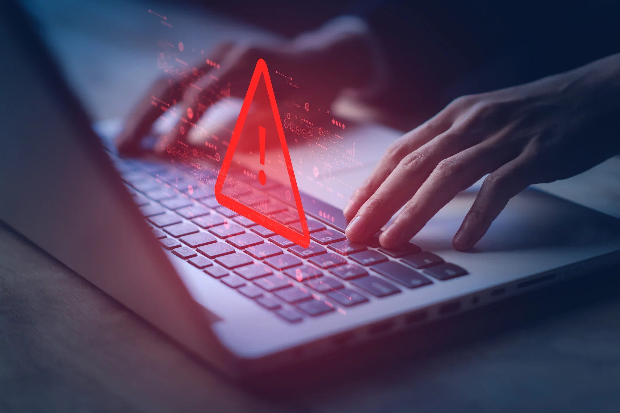 laptop with warning triangle for hacked